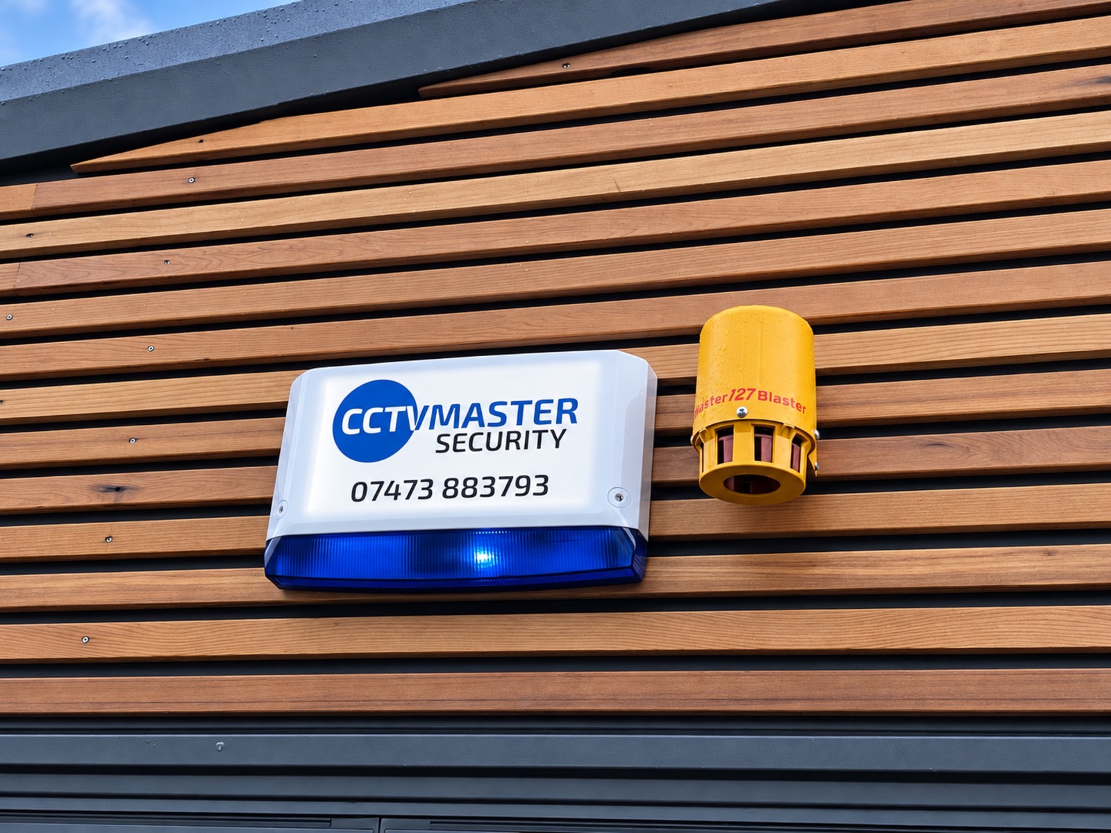 CCTVMaster branded intruder alarm and yellow external sounder on timber cladding